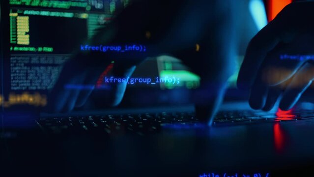 Close up of developing programming and coding technologies. Programmer hands are typing on keyboard. Software coder or blockchain developer at night. Concept of bitcoin cryptocurrency and wallet hack