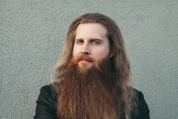 Man portrait Scandinavian european thirty years old long bearded with long loose red hair...