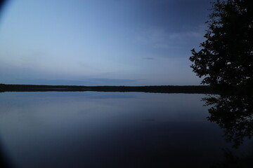 Calm surface of the night lake landscape. Long Exposure.
