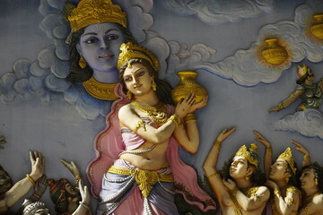 sculpture artwork of a woman with god krishna painting