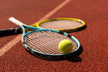 Tennis scene with balls, racquets and hard court surface corner lines