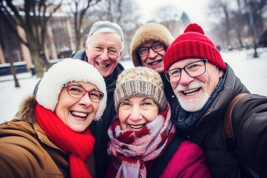Happy group of senior people smiling at camera outdoors.  Older friends taking selfie picture with smartphone, life style concept with pensioners having fun together on winter holiday