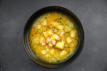 rice soup vegetable broth, potato, carrot, onion healthy eating cooking appetizer meal food snack on the table copy space food background rustic top view keto or paleo diet vegetarian vegan