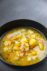 rice soup vegetable broth, potato, carrot, onion healthy eating cooking appetizer meal food snack on the table copy space food background rustic top view keto or paleo diet vegetarian vegan