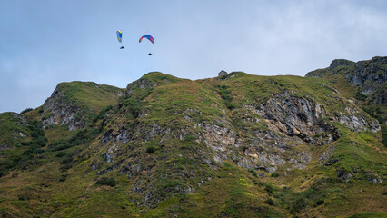 Paragliders flying over the mountains around the village of La Frua. It's located at extreme northern side of Piedmont (Northern Italy), at the border between Italy and Switzerland.