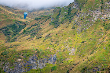 Paragliders flying over the mountains around the village of La Frua. It's located at extreme...