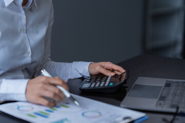 Fototapeta premium Asian businessman using laptop computer and smartphone contact business search information on desk in the office. checks mail, 