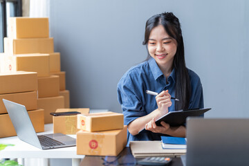 startup girl Small SME business owners work with laptop computers at work. with parcel paper boxes for delivery to customers online selling, Ecommerce,