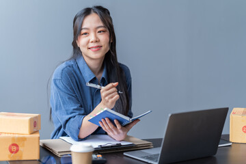startup girl Small SME business owners work with laptop computers at work. with parcel paper boxes for delivery to customers online selling, Ecommerce,	
