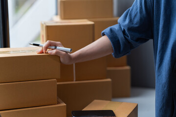 Close-up woman hand press calculator to calculate the company's financial results, tax, accounting,...