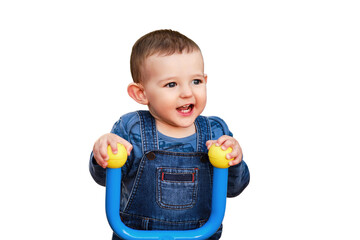 Happy child sitting behind the wheel of a toy tractor car in the playground, isolated on a white background