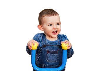 Happy child sitting behind the wheel of a toy tractor car in the playground, isolated on a white background