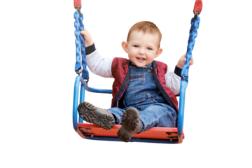 Happy toddler baby boy rides on a swing, isolated on a white background. Smiling child swinging on the playground, kid aged one year