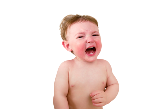 Crying screaming toddler baby boy is lying on the bed, isolated on a white background. Unhappy child close-up on a white blanket, isolated on a white background. Kid aged one year (12 months)