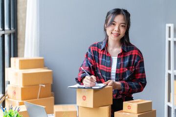 startup girl Small SME business owners work with laptop computers at work. with parcel paper boxes for delivery to customers online selling, Ecommerce,	