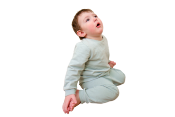 Little baby coughs sitting on the cold laminate floor in the house, isolated on white background. Small child is sick and coughing in the home living room. Kid aged one year nine months