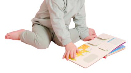 Happy toddler baby is reading a book on studio, isolated on white background. Child boy plays with a book, isolated on white background. Kid age one year eight months