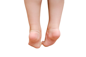 The little child is climbing on a high sofa, he could fall down and get hurt, isolated on white background. Baby legs close-up, isolated on white background. Kid aged two years (two-year-old boy)