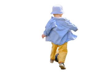 Baby boy is practicing soccer skills on the green field in the yard, isolated on white background. Kid aged about two years