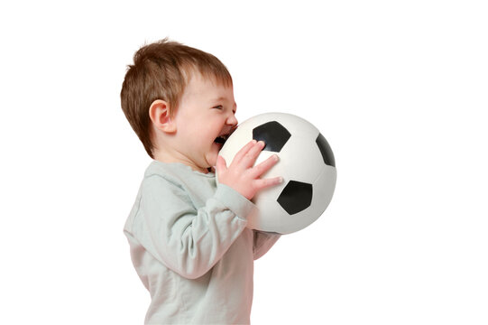 Happy toddler baby with a soccer ball on a studio, isolated on white background. Child boy holding a sports ball in his hands, isolated on white background. Kid age one year eight months