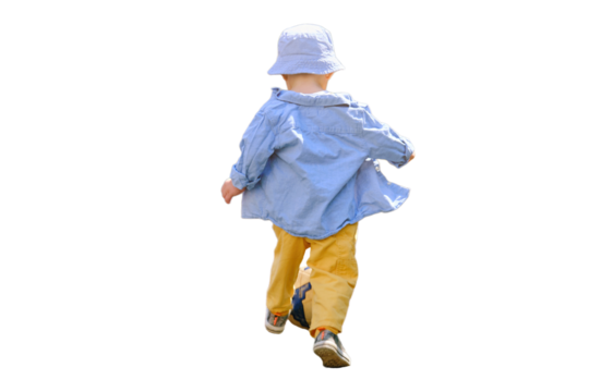 Baby boy is practicing soccer skills on the green field in the yard, isolated on white background. Kid aged about two years