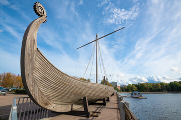 Viking longship close-up on a sunny September day. City embankment of Vyborg