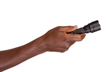 Hand holding a black flashlight or a torch isolated on transparent or white background