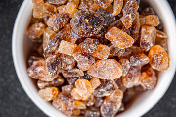 cane sugar rock sugar crystals pieces candy brown sugar candied sugar big rock caramel eating appetizer meal food snack on the table copy space food background rustic top view