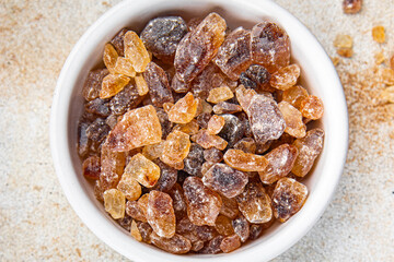 cane sugar rock sugar crystals pieces candy brown sugar candied sugar big rock caramel eating appetizer meal food snack on the table copy space food background rustic top view