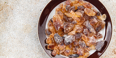 cane sugar rock sugar crystals pieces candy brown sugar candied sugar big rock caramel eating appetizer meal food snack on the table copy space food background rustic top view