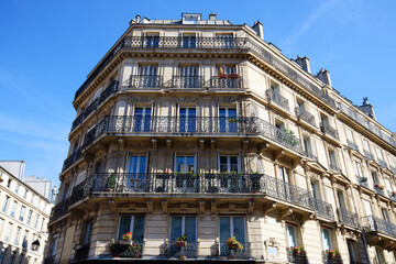 The facade of traditional French house with typical balconies and windows. Paris.