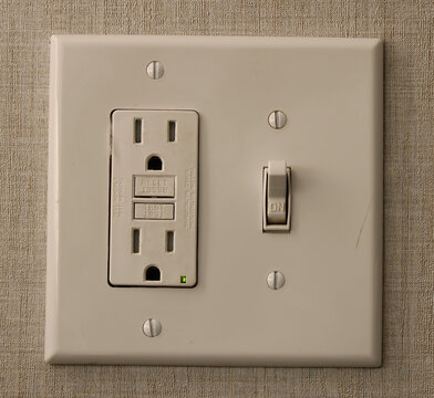 Light switch and electrical outlet on wall