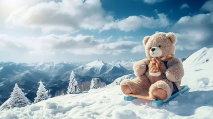 Poster A teddy bear sits on skis and looks at snowy winter mountains. Christmas and winter holidays © Zahid