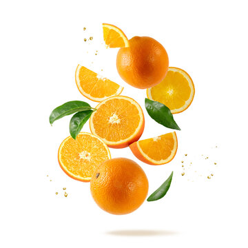 Fresh orange fruit whole and slices with leaves falling flying isolated on white background