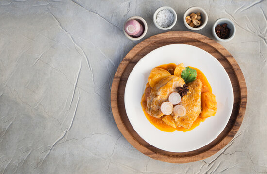 Top view of massaman curry with chicken and potatoes in plate on cement background. Thai Food