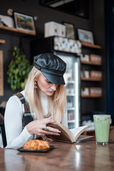 Woman reading a book in a coffee shop