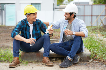 workers or architect taking a break at the construction site