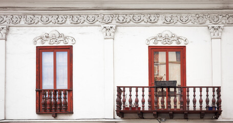 Street view of an old colonial building facade, architecture background, Cuenca, Ecuador.