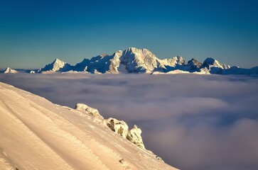 Winter landscape in Polish mountains. Snow covered peaks with beautiful clouds around. - 658740148