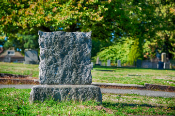 Large blank tombstone in cemetery.