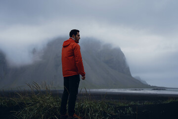 Boy walking in a desert black beach in Iceland