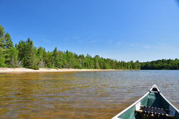 La Mauricie National Park Caribou lake. Perfect day to go out in canoe. Blue sky and sand beach