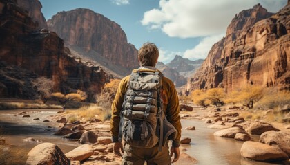 Fototapeta na wymiar Backpacker hiking by the Canyon overlooking. Desert tones
