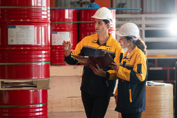 Two factory workers or inventory inspector conduct professional inspection on hazardous chemical...