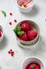 ice cream or sorbet with red berries red currant and basil on wood background. home-made ice cream close up cook book - obrazy, fototapety, plakaty