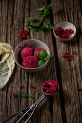 ice cream or sorbet with red berries red currant and basil on wood background. home-made ice cream close up cook book