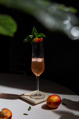 refreshing summer cocktail with peach and mint with copy space. prosecco and peach juice with ice cubes