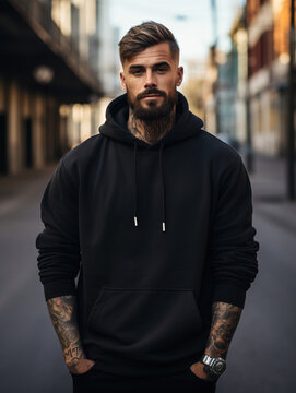 City portrait of handsome man wearing blank mockup black hoodie or sweatshirt with space for your logo or design