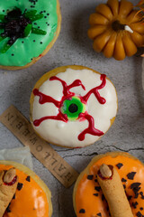 halloween sweet donuts top view. colorful donuts glazed and decorated for trick or treat.