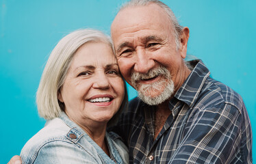 Happy Latin senior couple smiling into the camera - Elderly people and love relationship concept
